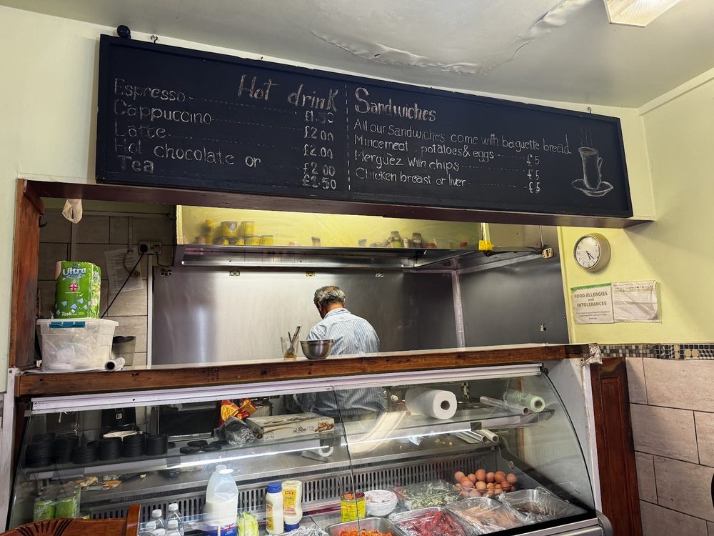 The open kitchen and chilled display counter, with the chef working behind it.