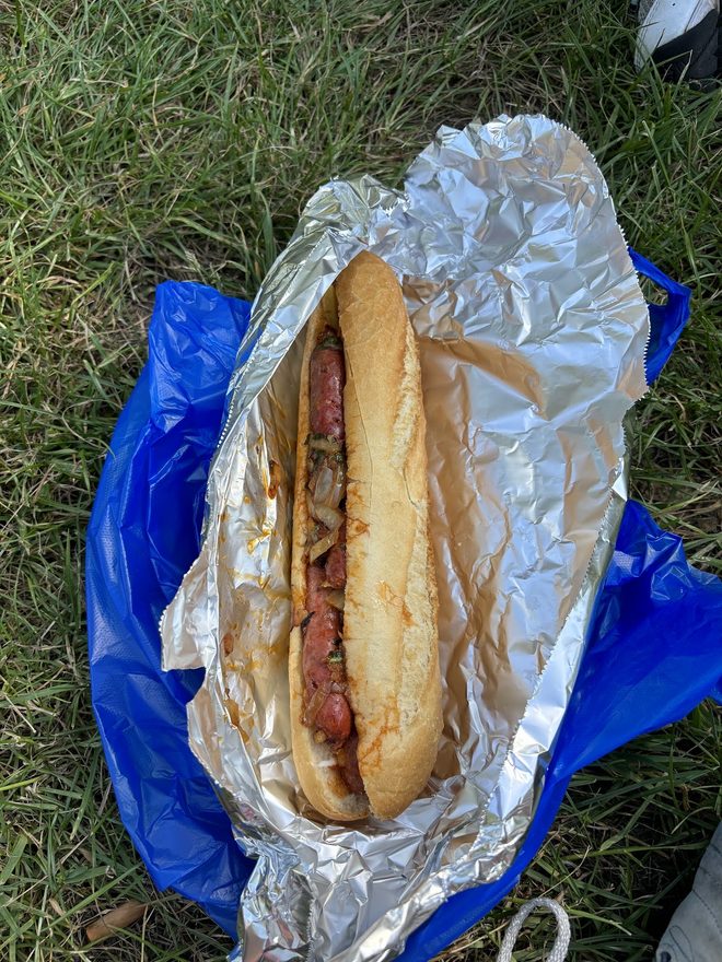 A foil-wrapped baguette taken out to the park.