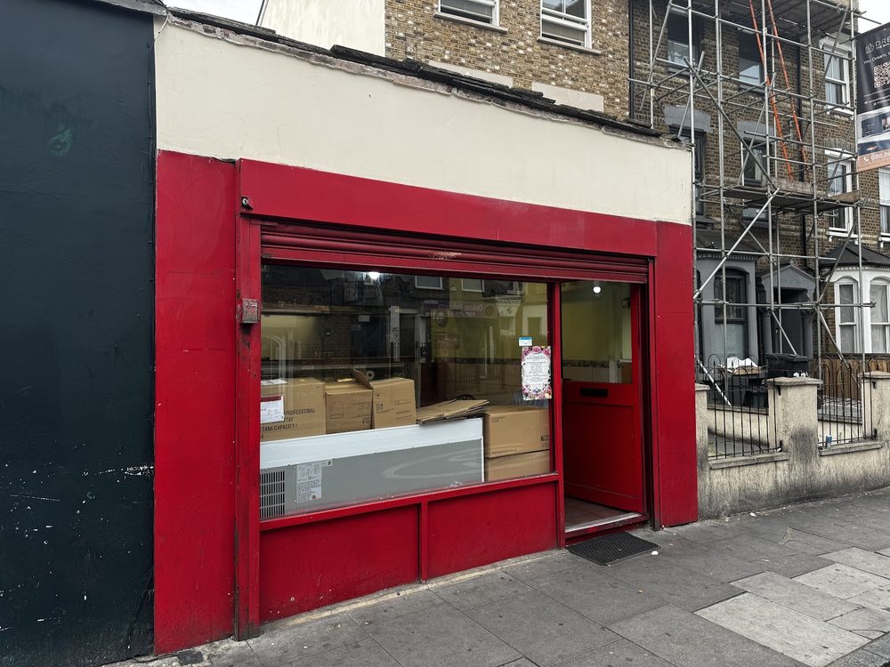The red-framed shopfront of Cafe Salaam & Sandwiches on Rock St, seen from across the road with the door open.