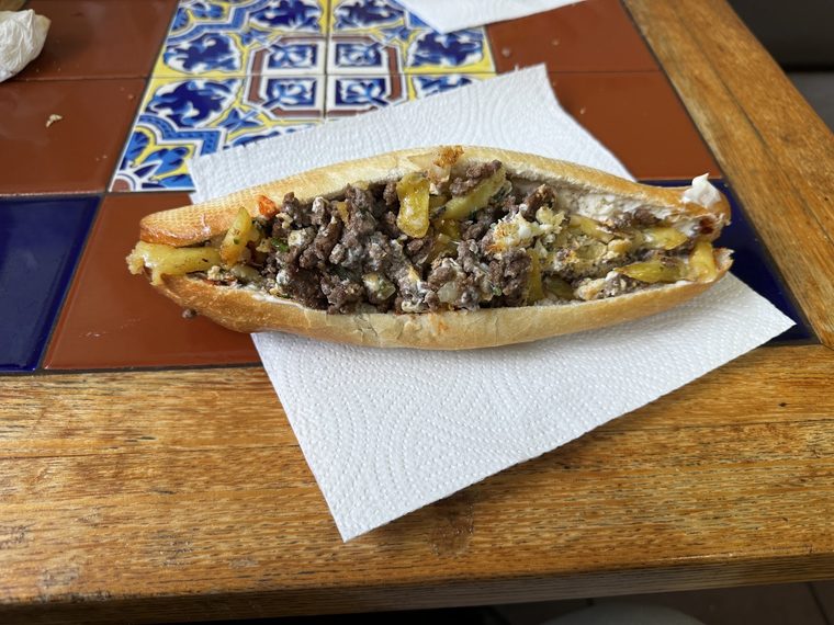 Baguette with minced meat, potato and chilli.